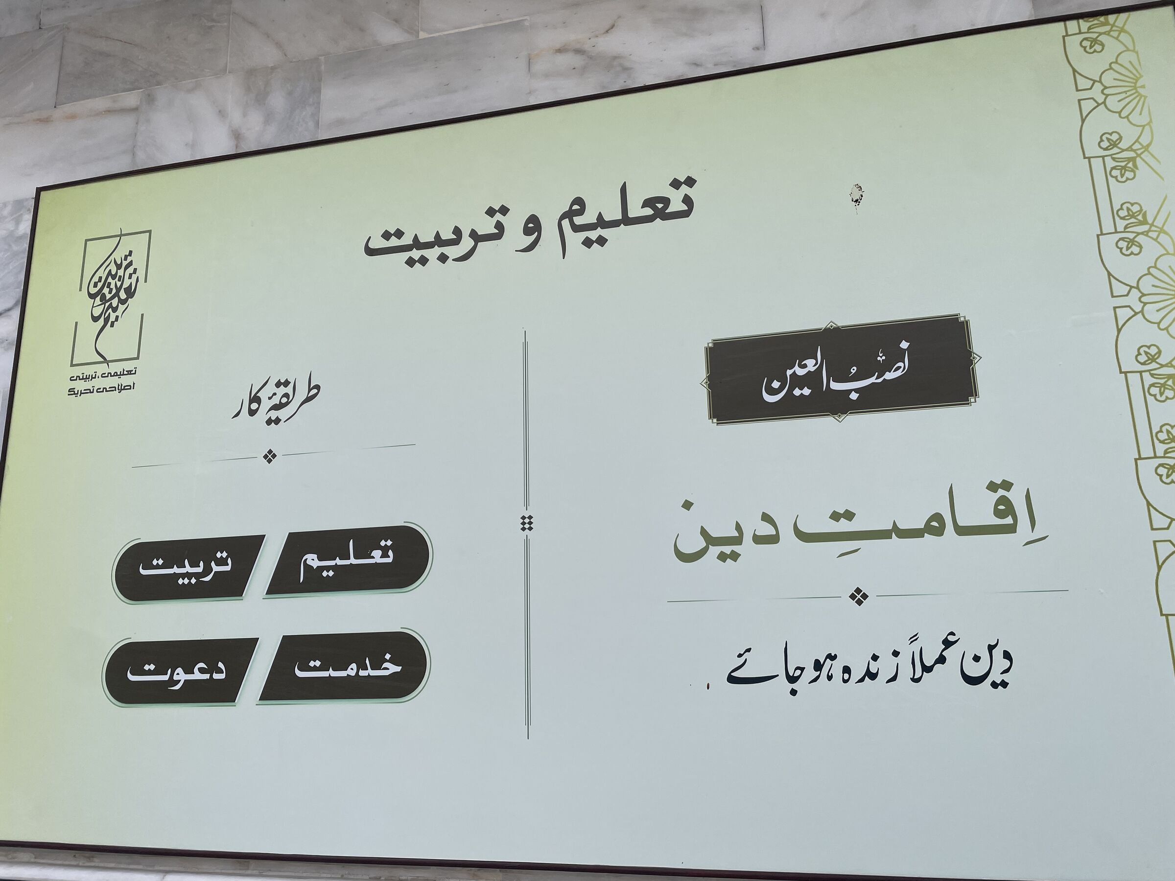 بورڈ جس پر نصب العین «اقامتِ دین» اور طریقۂ کار کے چار ستون درج ہیں۔